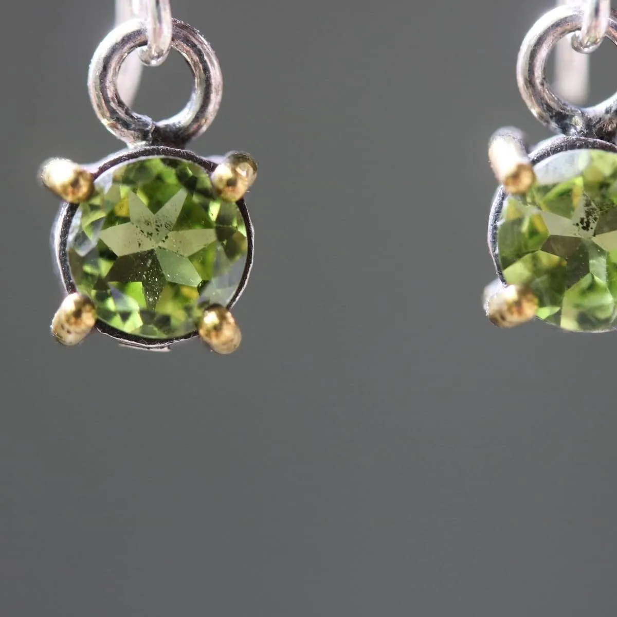 Earrings round faceted peridot in silver bezel and brass prongs setting with sterling silver hooks style